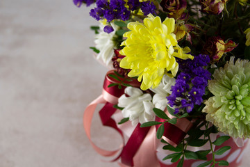 Floral bunch in round box. Bouquet in red color of beautiful Mixed flowers. Excellent garden flowers in the arrangement , the work of a professional florist. Gift box