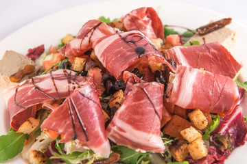 Plate of lamb's lettuce salad with croutons, Iberian ham, Iberian mousse and balsamic vinegar from Modena