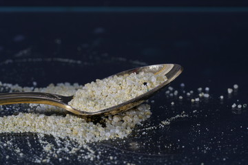 Sweet sugar on a golden spoon photographed in the studio with flash 