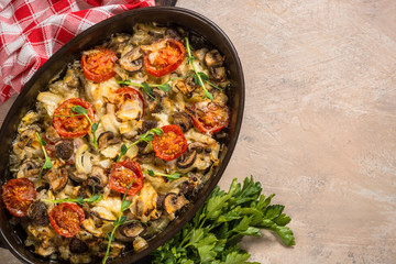 Baked meat with vegetables top view.