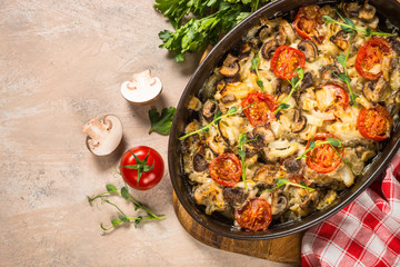 Baked meat with vegetables top view.