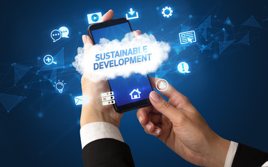 Female hand holding smartphone with SUSTAINABLE DEVELOPMENT inscription, cloud technology concept