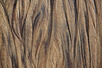 Wet sea sandstone with traces of groundwater smudges