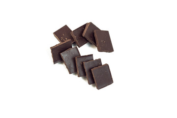squares of dark chocolate stand behind each other forming the shape of a hook