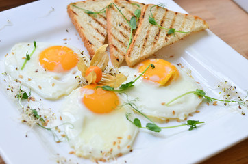 food, fried eggs with vegetables and toast on a plate