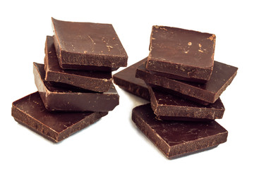 squares of dark brown chocolate form two chocolate towers