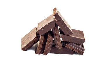 a mountain of dark chocolate pieces is stacked in a pyramid