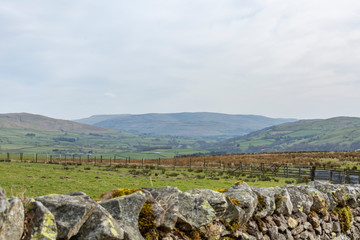 mountain landscape with blue sky and clouds looking from a wall in Cumbria