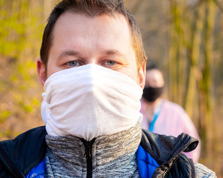 Keeping Social Distance While Walking Outside During Coronavirus Quarantine In Homemade Face Masks