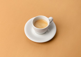 Espresso coffee in white cup on beige table. Pop art minimal flat lay creative composition
