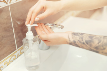 Obraz na płótnie Canvas Coronavirus protection washing hands with tattoo with soap woman