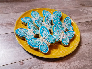 Abstract butterfly cookies on a yellow plate and background