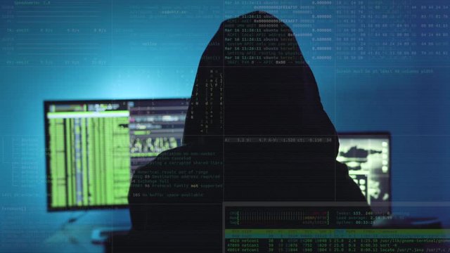 Hooded hacker attacking Data Server Hacker stealing secure information from server