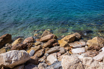 Fototapeta na wymiar Spring beautiful day by the sea on the rocky seashore of the southern suburbs of Athens, Greece.