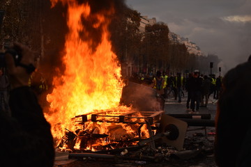 Pile of things burning on the street by yellow vest protestors in Paris France