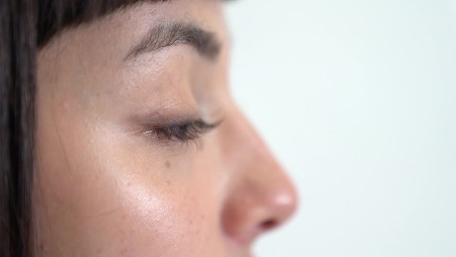 A young asian girl speaks about anything. Close up shot.