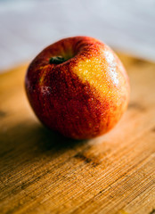 red apple on wooden table