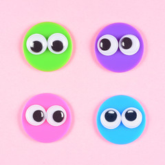 Four strange characters with round faces and mad googly eyes looks to each other. Valentines Day, close up googly eyes.
