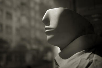 Male mannequin head in store window