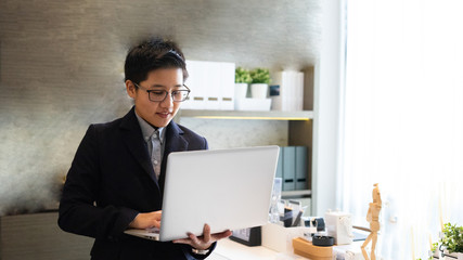 The business man holding computer laptop  happy he  successfully in job though he work from home online working, he smile happy he using technology and innovation to work. 
