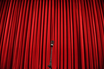 Microphone in front of a red curtain
