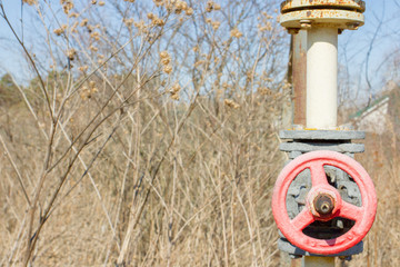 Old red gas vent on a yellow rusty pipe