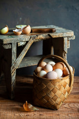 fresh organic village eggs on wooden table, healthy food,  village food. black pan with fried egg. small bench background