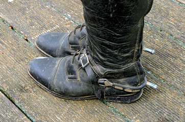 black riding boots with buckled spurs
