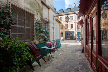 Fototapeta na wymiar Cafe in cobblestone ally in old part of versailles, France