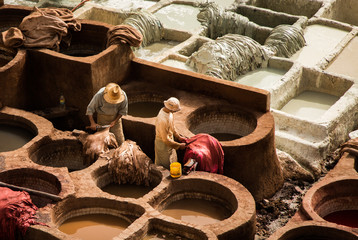 Men working in a tannery in Morocco with many colors.