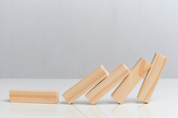 Business collapse concept. Wooden blocks on a white background background.