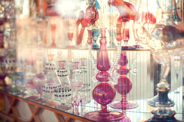 A lot of beautiful empty arabic style glass bottles for perfume in the shop behind the glass