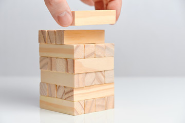 Big date creation concept. Hand holds wooden blocks on a white background.