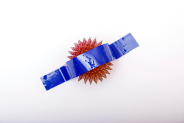 A coronavirus taped to the white background of the wall. The end of covid-19 ncov concept. Popular image. New trend in photography. A conceptual look at modern art. Artistic picture.