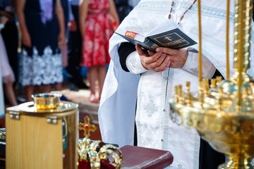 Orthodox religion. Hands of the priest on the bible..