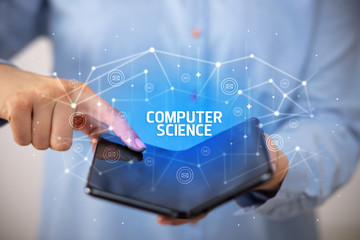 Businessman holding a foldable smartphone with COMPUTER SCIENCE inscription, new technology concept