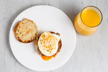 Egg, sausage and cheese breakfast sandwich with orange juice