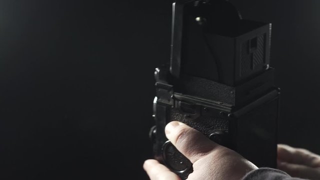 old camera on dark background - load the shutter and take photographs with a vintage camera
