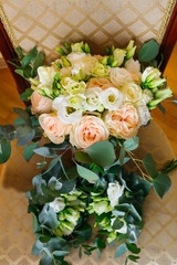 top view of chair with elegant bouquet of bride and two bouquets