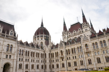 Fototapeta na wymiar Building of the Hungarian Parliament Orszaghaz in Budapest, Hungary. The seat of the National Assembly. Detail photo of the facade. House built in neo-gothic style. Horizontal photo