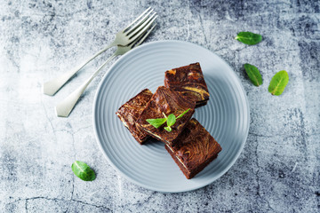 Cream cheese chocolate brownie with mint leaves