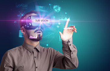 Businessman looking through Virtual Reality glasses with OUR VISION inscription, new business concept
