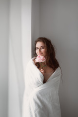 Stock photo - I stay at home awareness social media campaign and coronavirus prevention. Stay home phrase. Girl under the covers in her bed