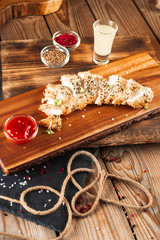 Baked fish in breadcrumbs with sauce.