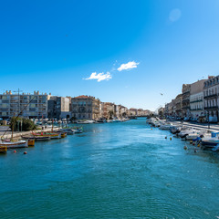 Sète in France, traditional boats moored at the quay in the city centre

