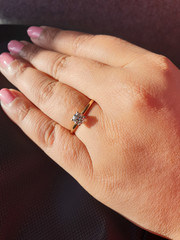 Female hand with a diamond ring in her finger