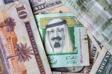 Saudia Arabia Riyal Placed Next To US Dollar And Chinese Yuan Closeup. Selective Focus