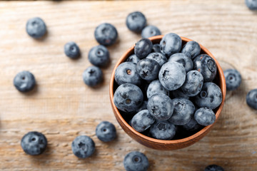 ripe blueberries on a wooden background