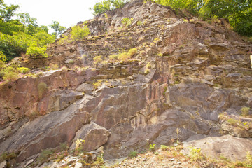Green forest . rocky path through the mountains . rocky wall of a peak mountain . beautiful rocky mountain and greenery pasture . Rocky mountains by the road.
