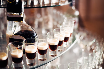 closeup of bottle with exquisite drink and wineglasses. wedding